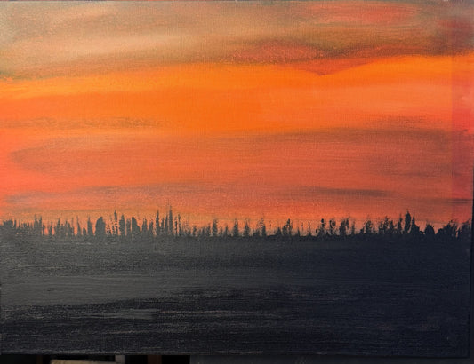 Surreal landscape with orange sky and dark silhouette of trees